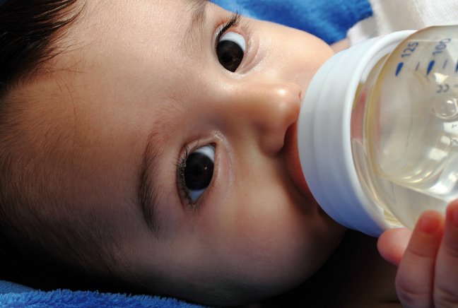 baby drinking water from a bottle